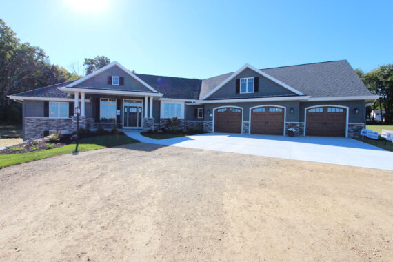 Exterior view of a single story home with three car garage