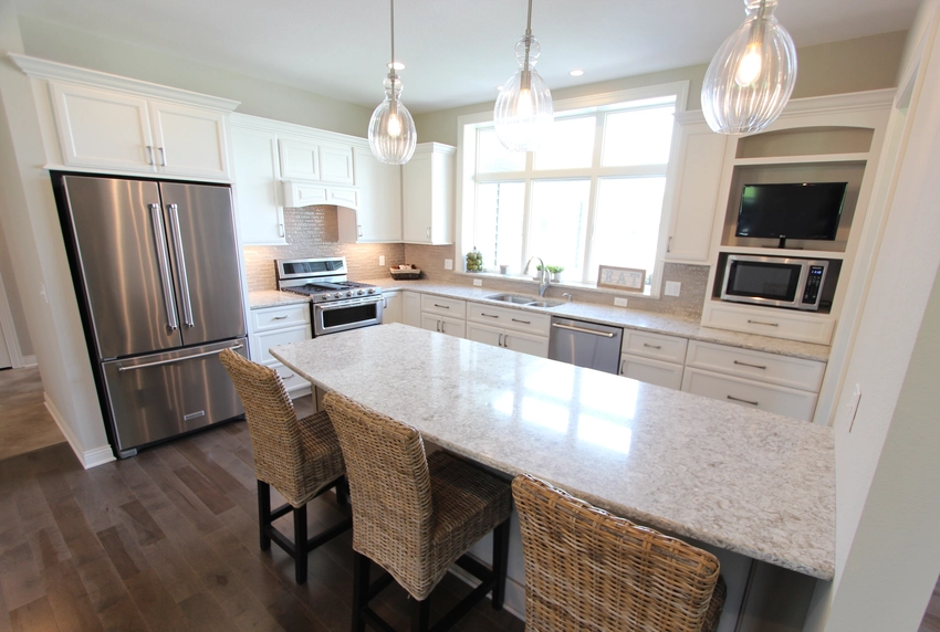 Modern kitchen with white cabinets and wood flooring