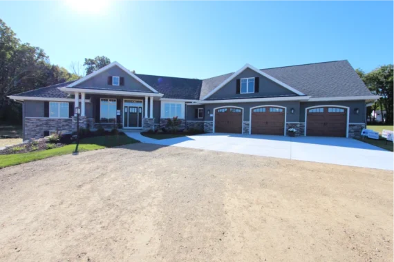 Exterior view of a single story home with three car garage